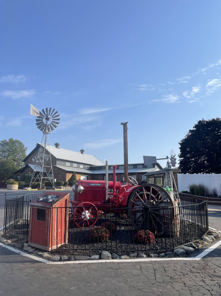 A red tractor sits at the entrance of Kuipers Family Farm.  